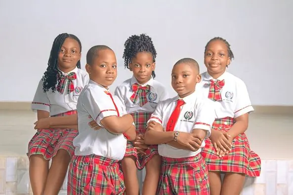 A group of pupils in red tartan uniforms posing together