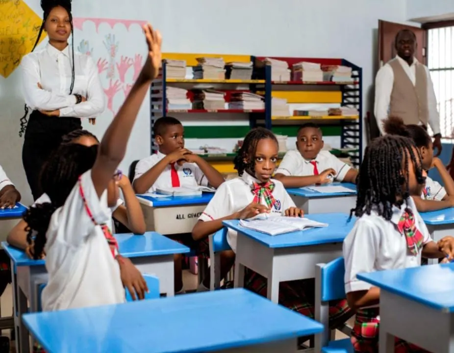 Pupils raising their hands during a lesson